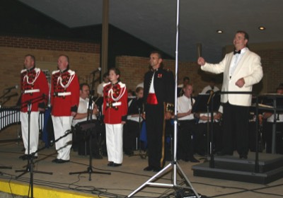  Col. Timothy Foley guest conducted the Wheaton Municipal Band. On that occassion, three former Wheaton Band members, also members of the President's Own United States Marine Band, came along. Roger Kantner (left), Jay Niepoetter, and Jennifer Marotta stand in uniform to Col. Foley's right.  