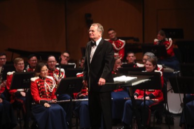  Dr. Moss stands in front of The President's Own United States Marine Band as guest conductor at the 89th annual American Bandmasters Association Convention. (March, 2024)  