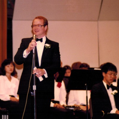  Moss addresses the audience at a York Varsity Band concert (1980).  